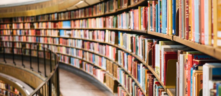 books on brown wooden shelf